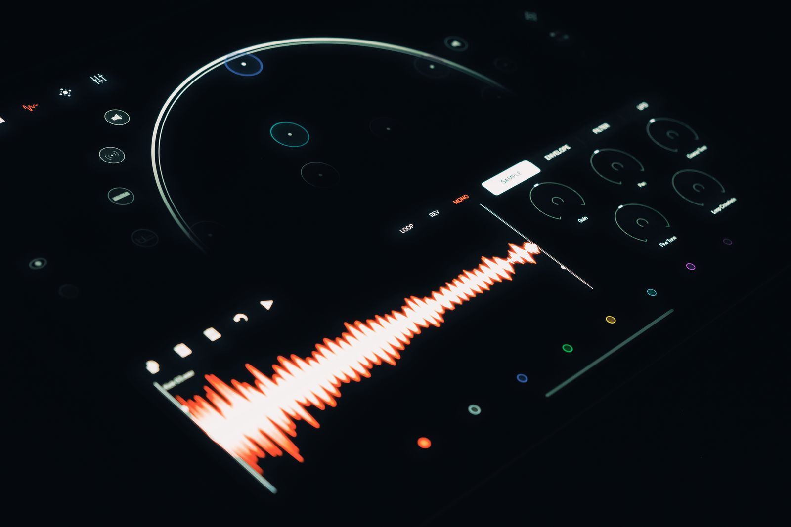 Close-up of a digital audio interface displaying a colorful sound wave and control buttons