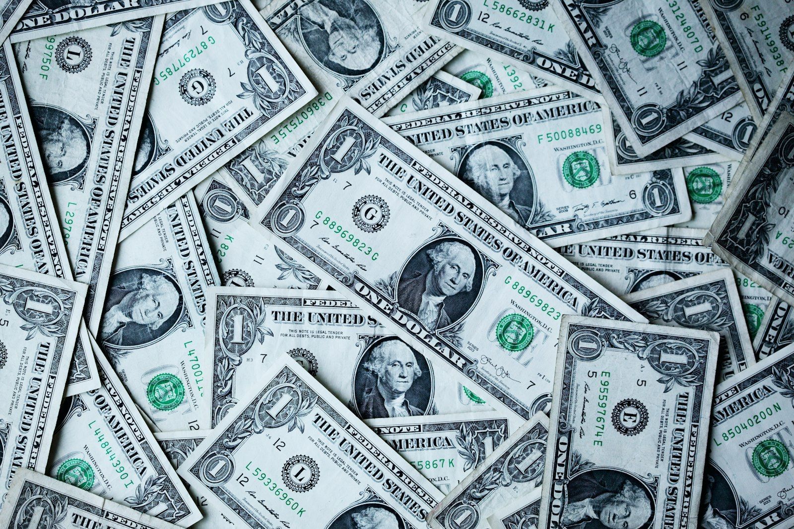 Scattered US one-dollar banknotes seen from above